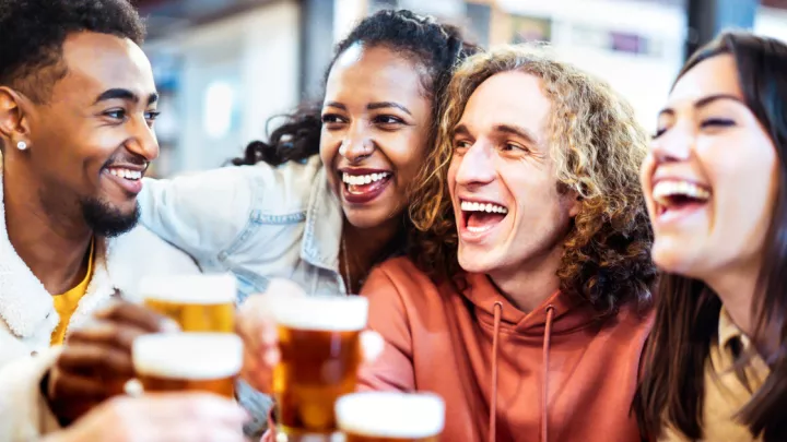 Two women and two men drinking beer