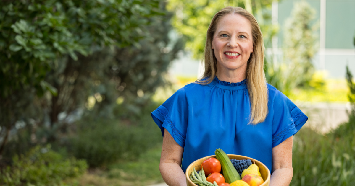 Rebecca Beaudoin, registered dietitian holding a basket of vegetables