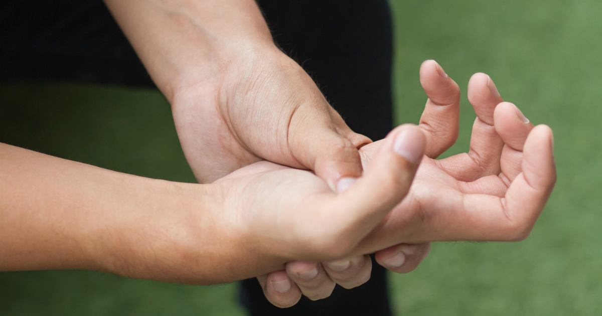 Close up of man holding hand in pain