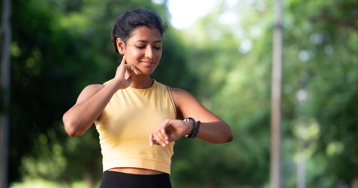 Woman exercising outside checking watch