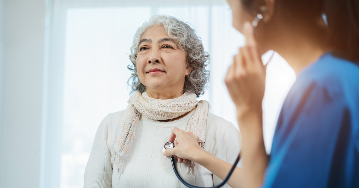 Doctor with stethoscope examining elderly patient with examination