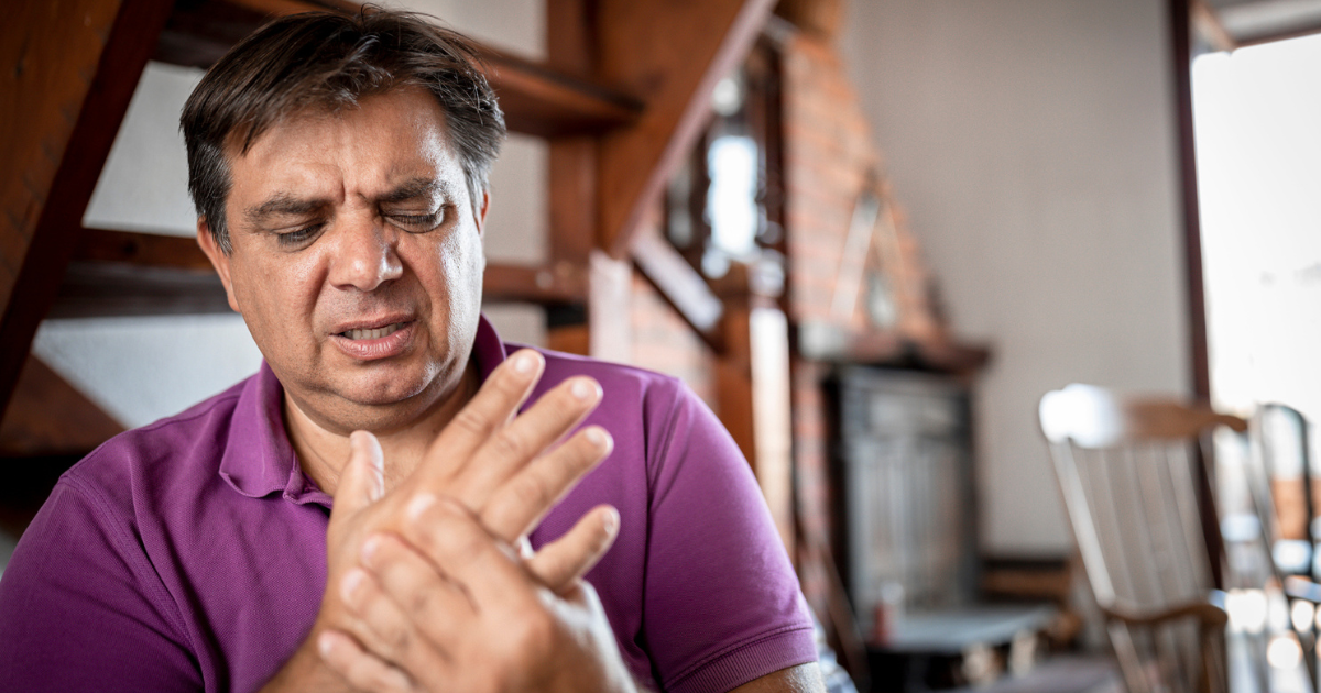 Man holding his hand in pain