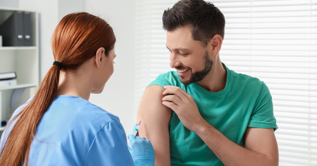 Nurse giving man a shot in arm