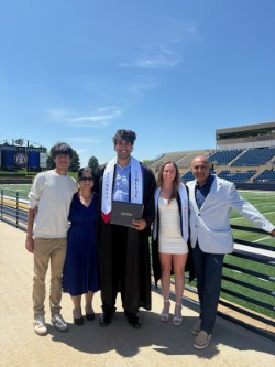 Shan in graduation robe with family
