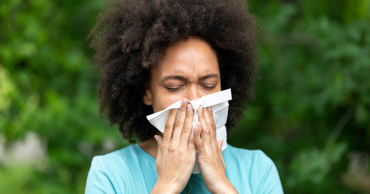 Woman blowing her nose