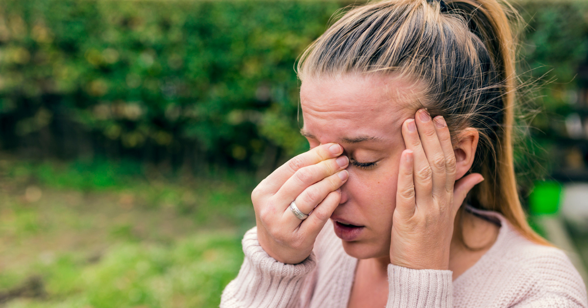 Woman holding her nose