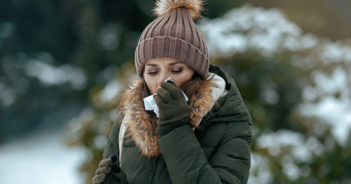 Woman blowing her nose