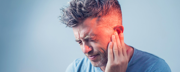 picture of a man holding his ear