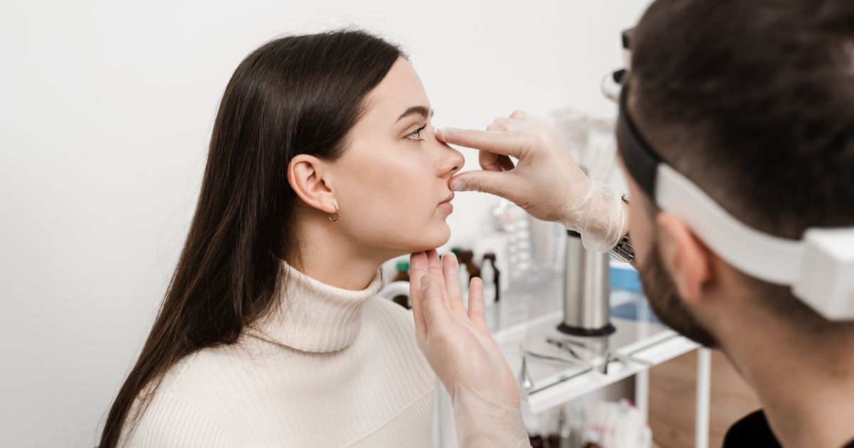 Doctor evaluating a woman's nose for a rhinoplasty