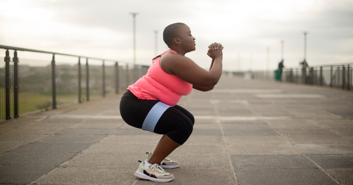 Woman doing squats on a bridge