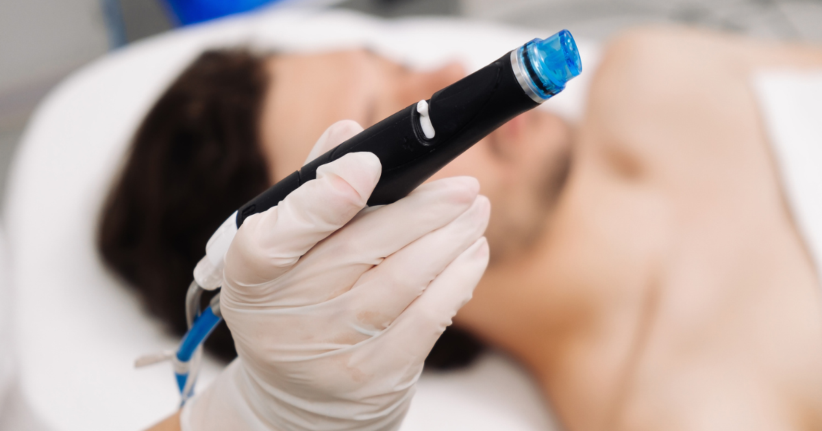 Provider holding Hydrafacial tool in front of man