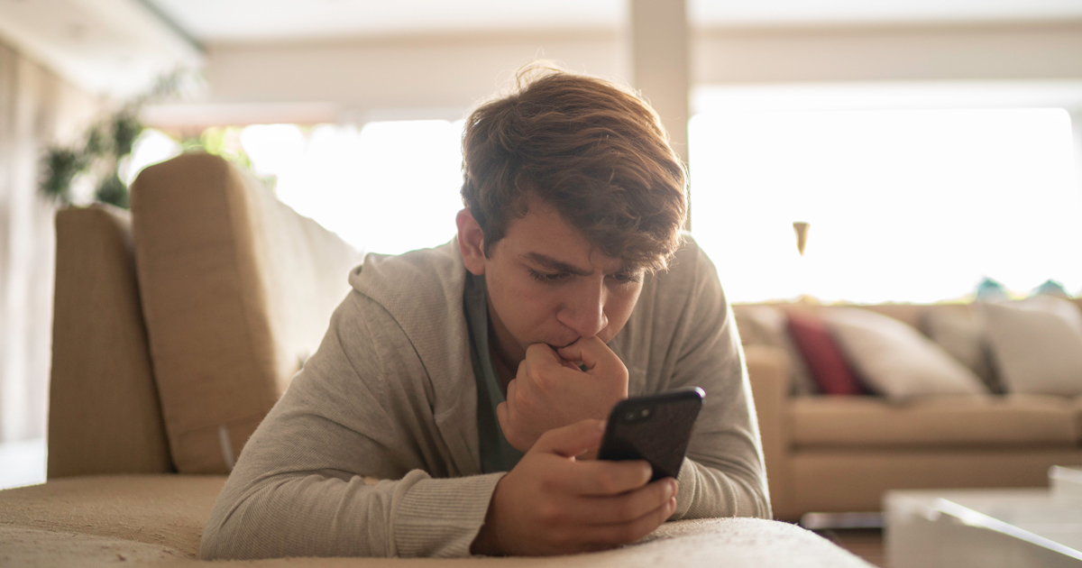 Teenage boy looking at his phone