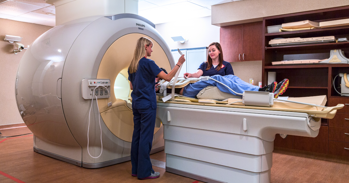 MRI technicians preparing patient for scan