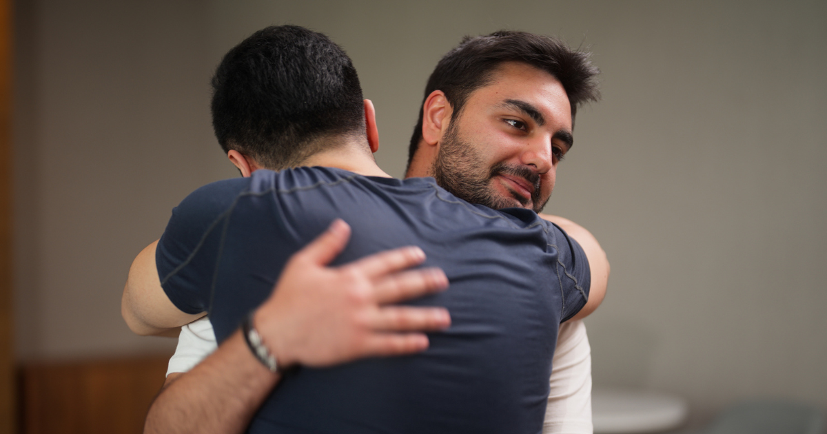 Two men hugging