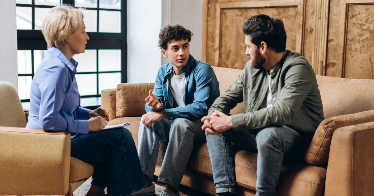Father and son talking to therapist