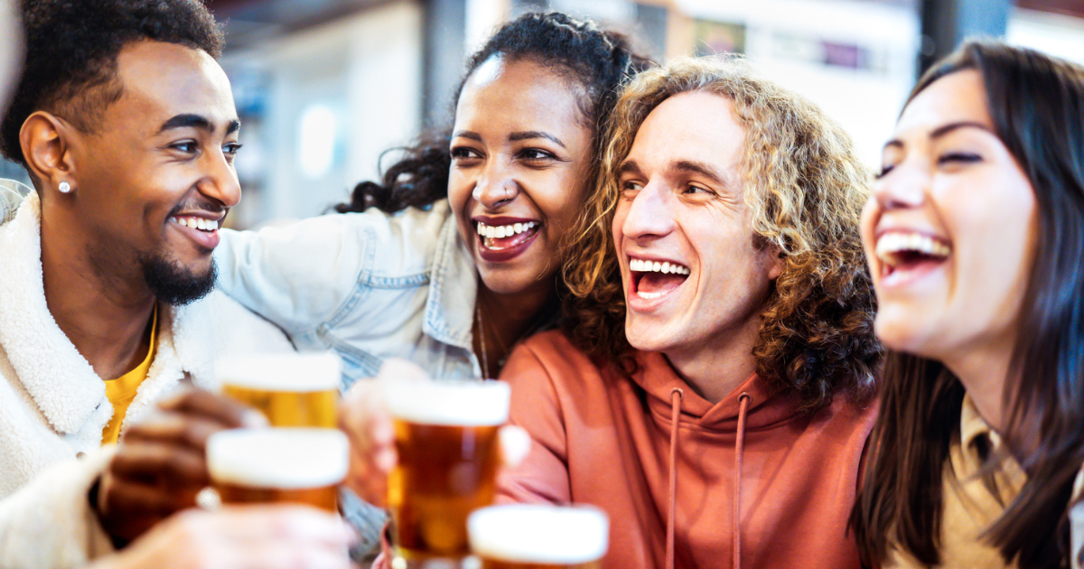 Two women and two men drinking beer