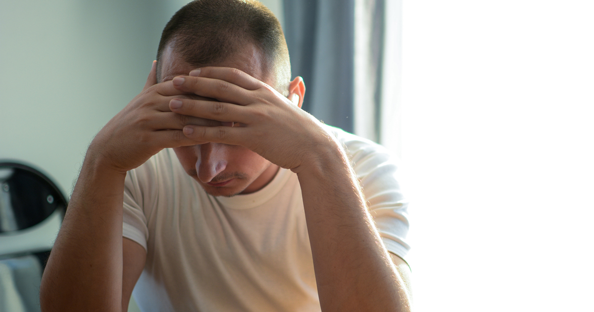 Man holding his head in his hands