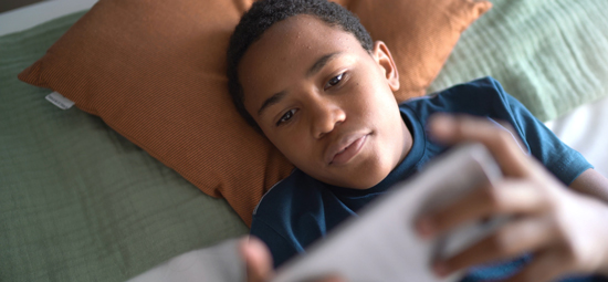 picture of a teenager looking at his phone