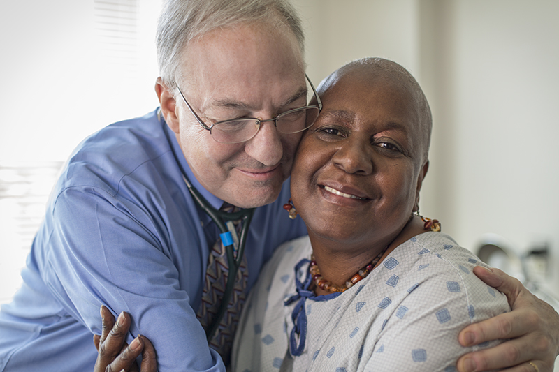 Kenneth Cowan, MD, PhD, pictured with one of his cancer patients.