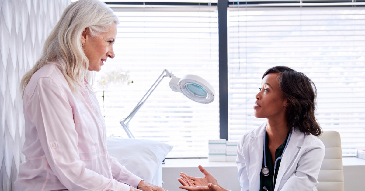 A picture of an older woman talking to her doctor