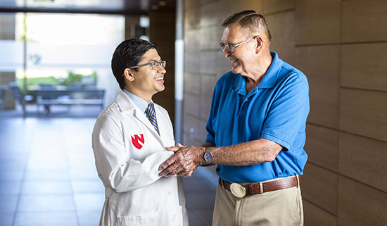 Vijaya Bhatt, MBBS, hematologist and medical oncologist, and Steve Waller, patient, visit following a check-up more than two years out from receiving a clean bill of after receiving treatment for leukemia.