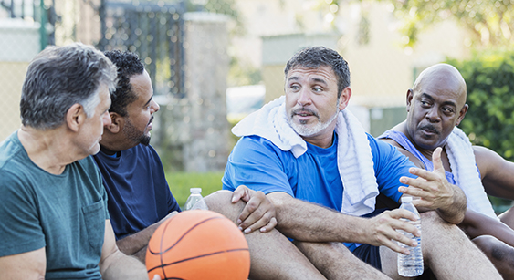 Group of men after a game of basketball. 