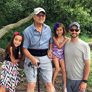 Ming Wang with two of his grandchildren and his son-in-law Dean Peterson. He has seven grandchildren total.