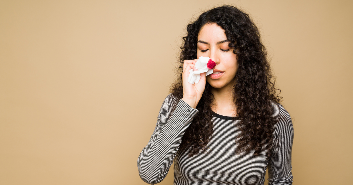 A picture of a woman with a nosebleed