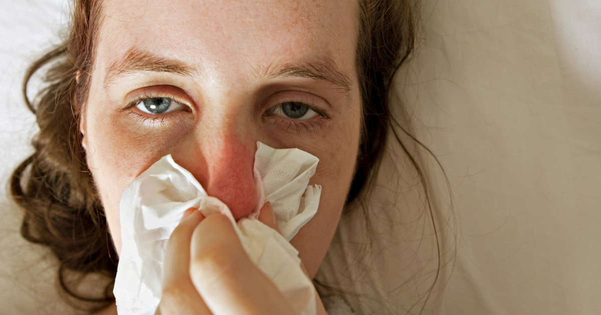 Woman blowing her nose