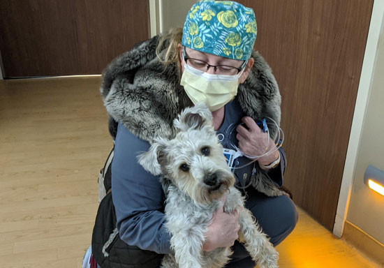 Bellevue Medical Center nurse Sandy Scholl with her new fur friend Harley.
