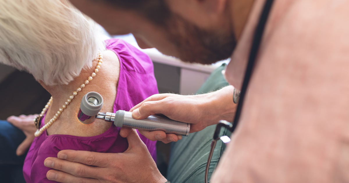 A picture of a woman getting her skin checked by a doctor