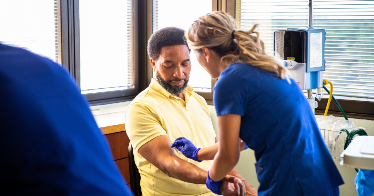 Man getting blood drawn by nurse