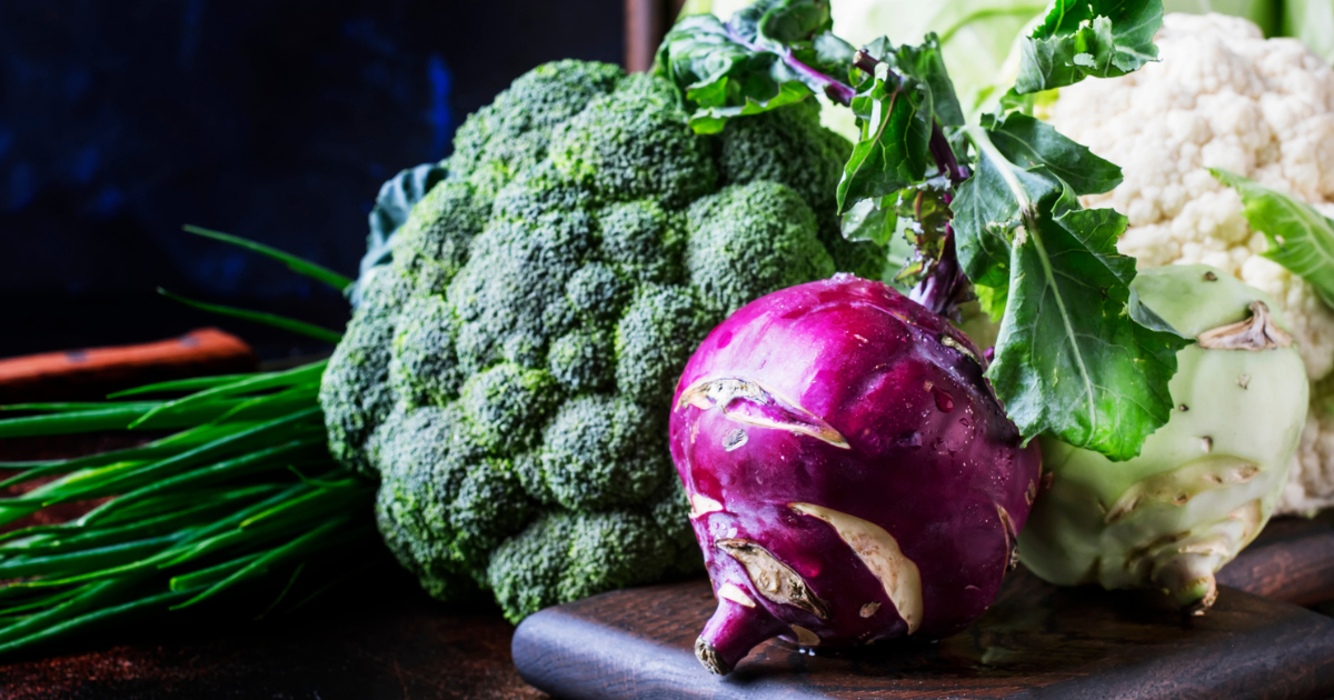 Different kinds of cabbage such as white cabbage, cauliflower, broccoli, kohlrabi on dark table, autumn harvest, selective focus