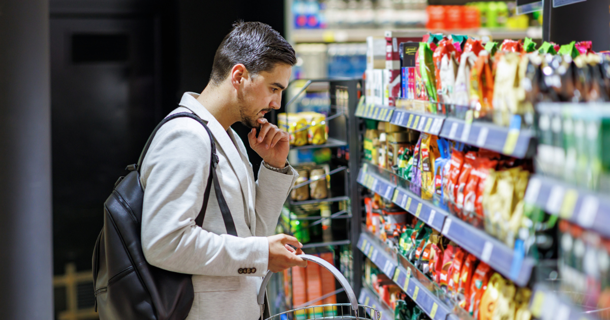 Man looking at grocery store shelf