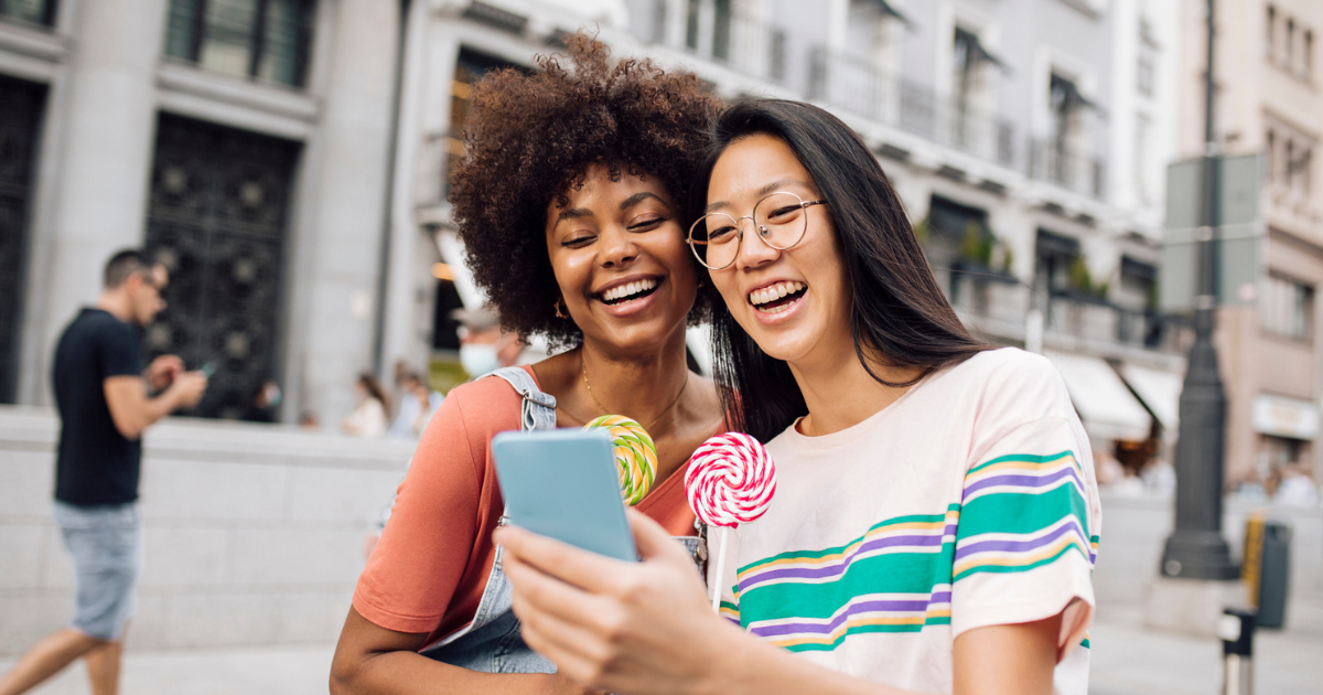 Two women with lollipops taking a selfie