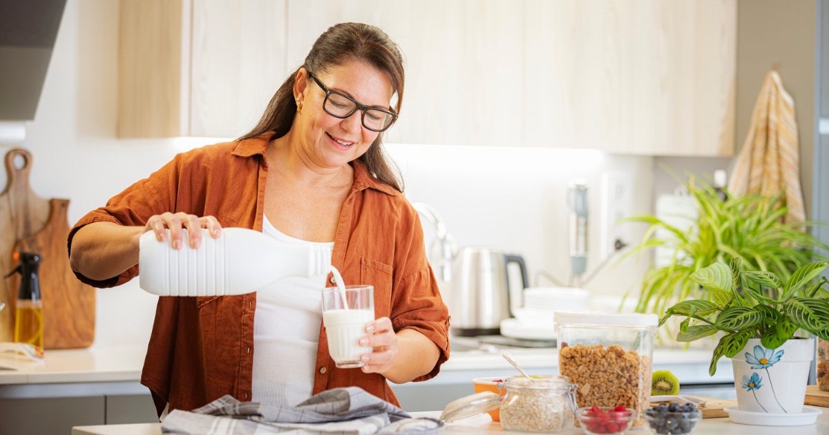 Woman pouring milk in a glass