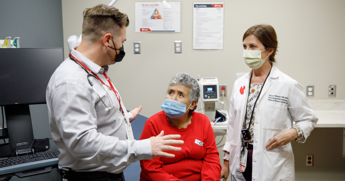 Matthew Lunning, DO and patient Maria Alvarran, accompanied by a medical interpreter.