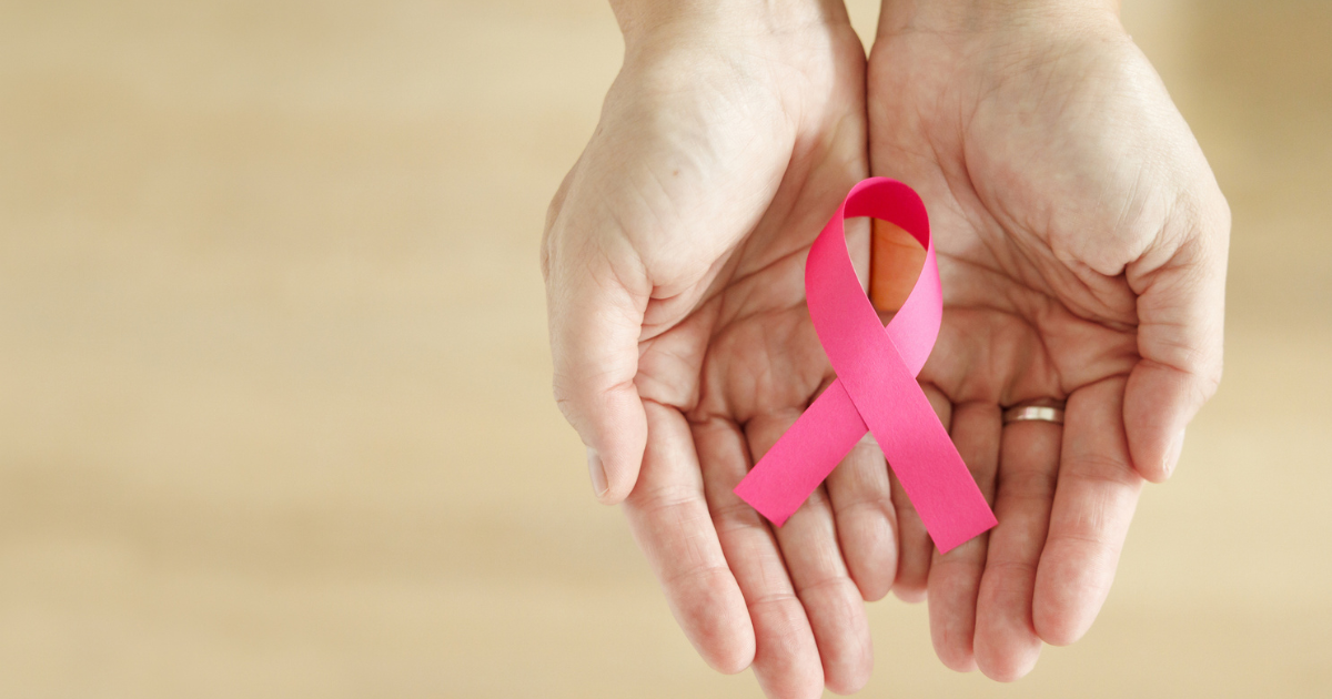 Hands holding pink breast cancer awareness ribbon