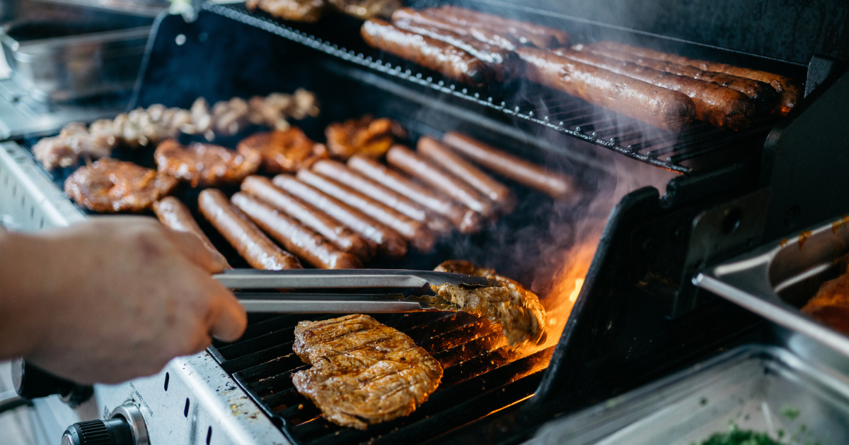 Close up of grilling hotdogs and other meats