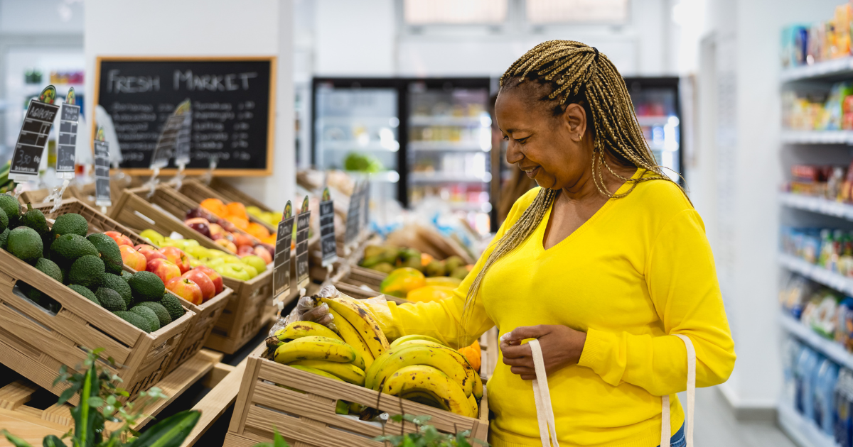 Women shopping produce in grocery store
