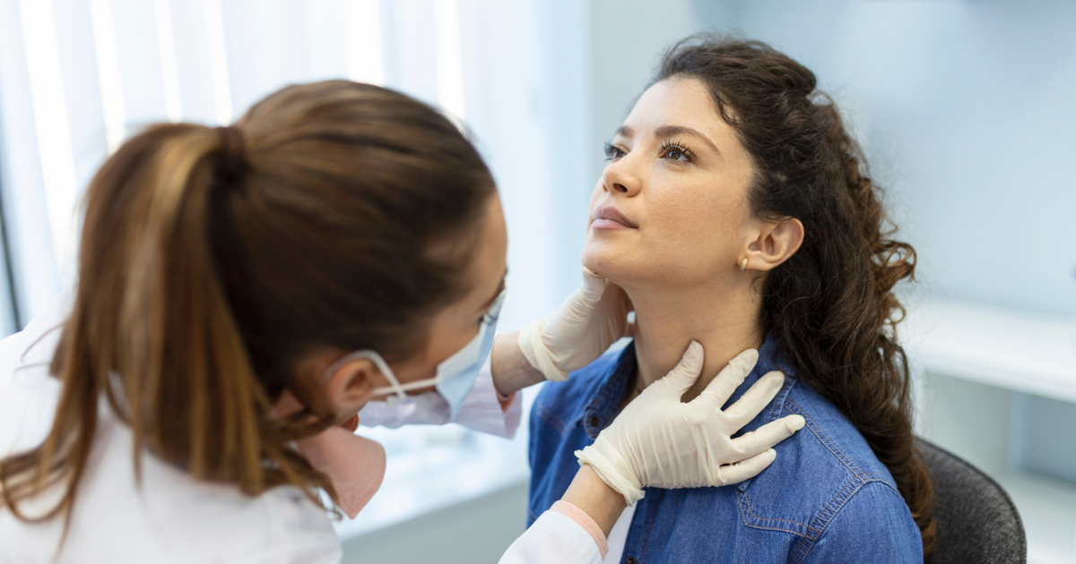 Doctor examining woman's neck