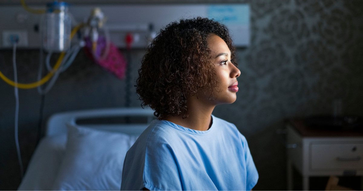 Woman sitting in a hospital gown