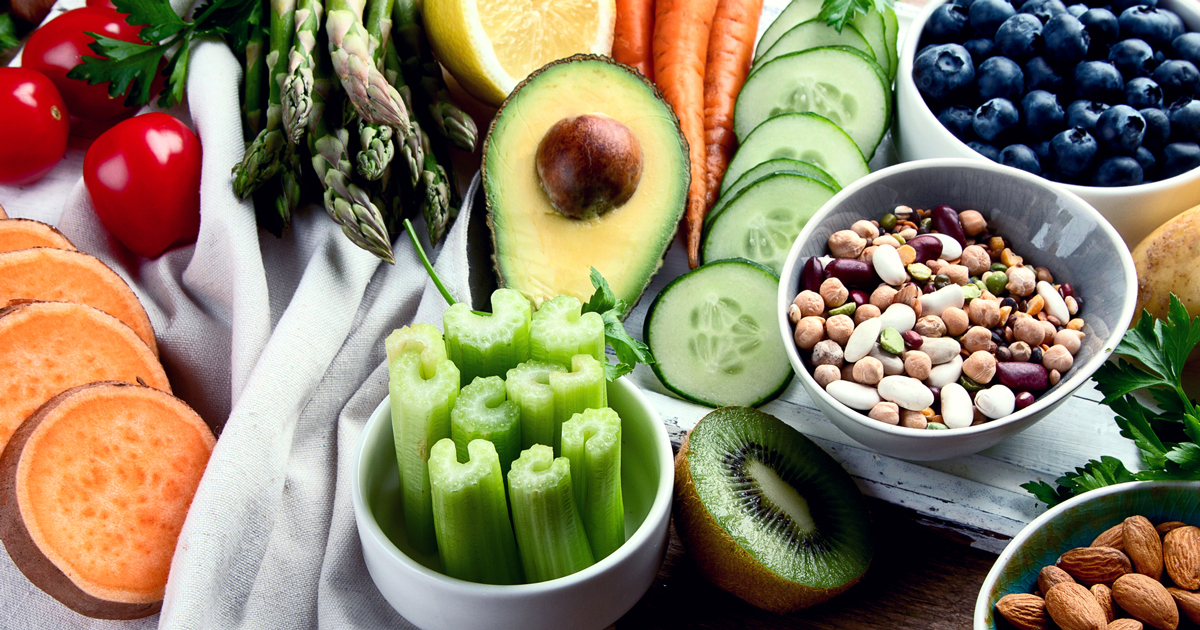 Table with various fruits, vegetables, and nuts