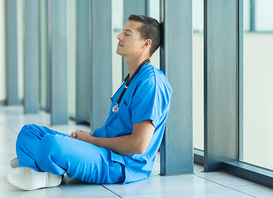 Nurse leaning against the wall