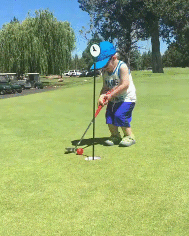 Child celebrating a successful golf putt