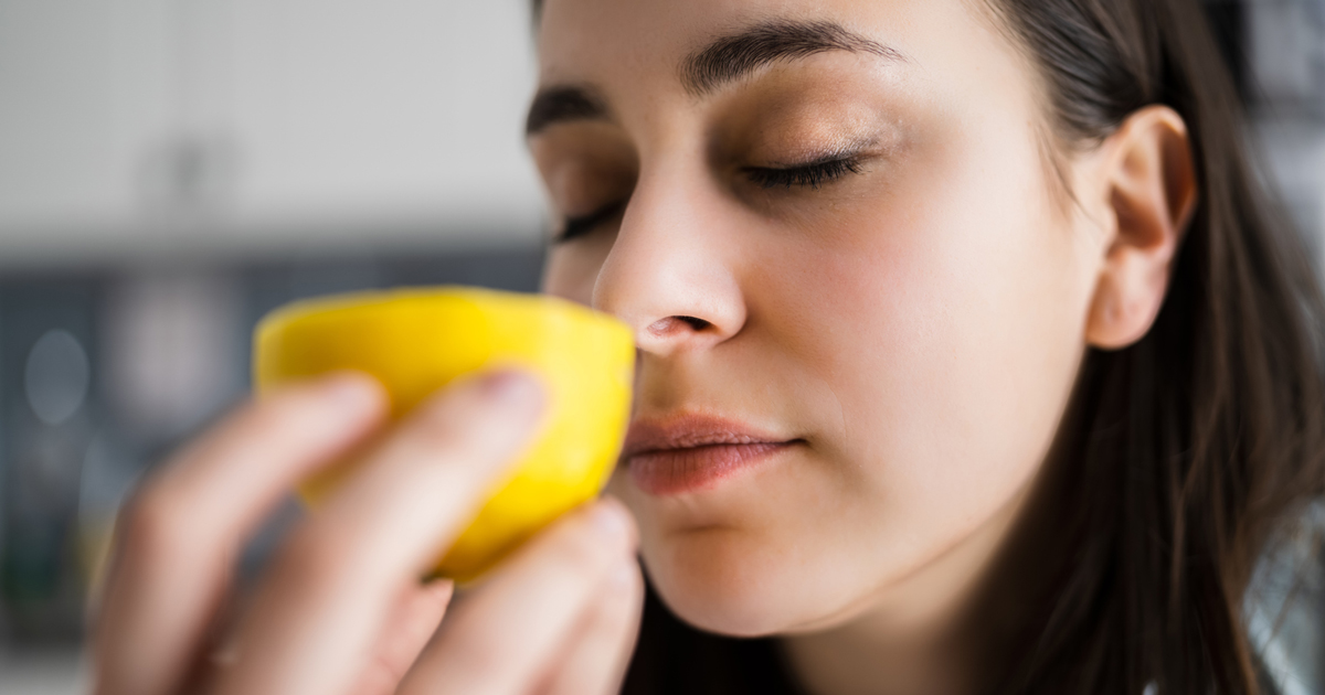 Woman smelling lemon