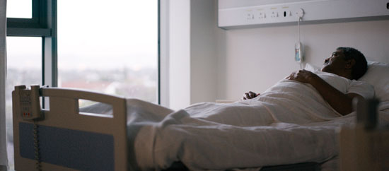 Elderly man in hospital bed