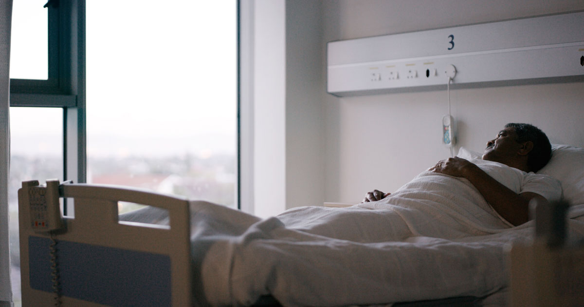 Elderly man in hospital bed