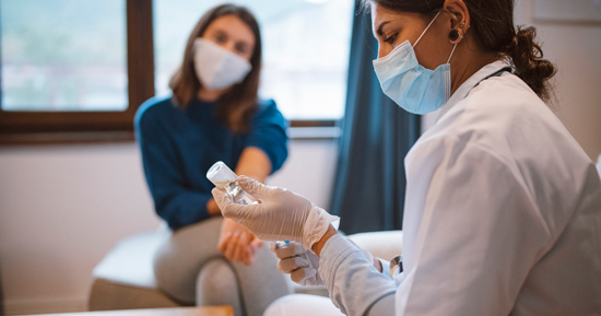 picture of a patient waiting for her COVID-19 vaccine