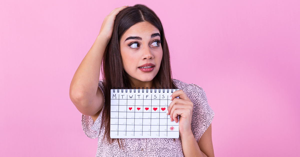 Woman holding calendar looking confused